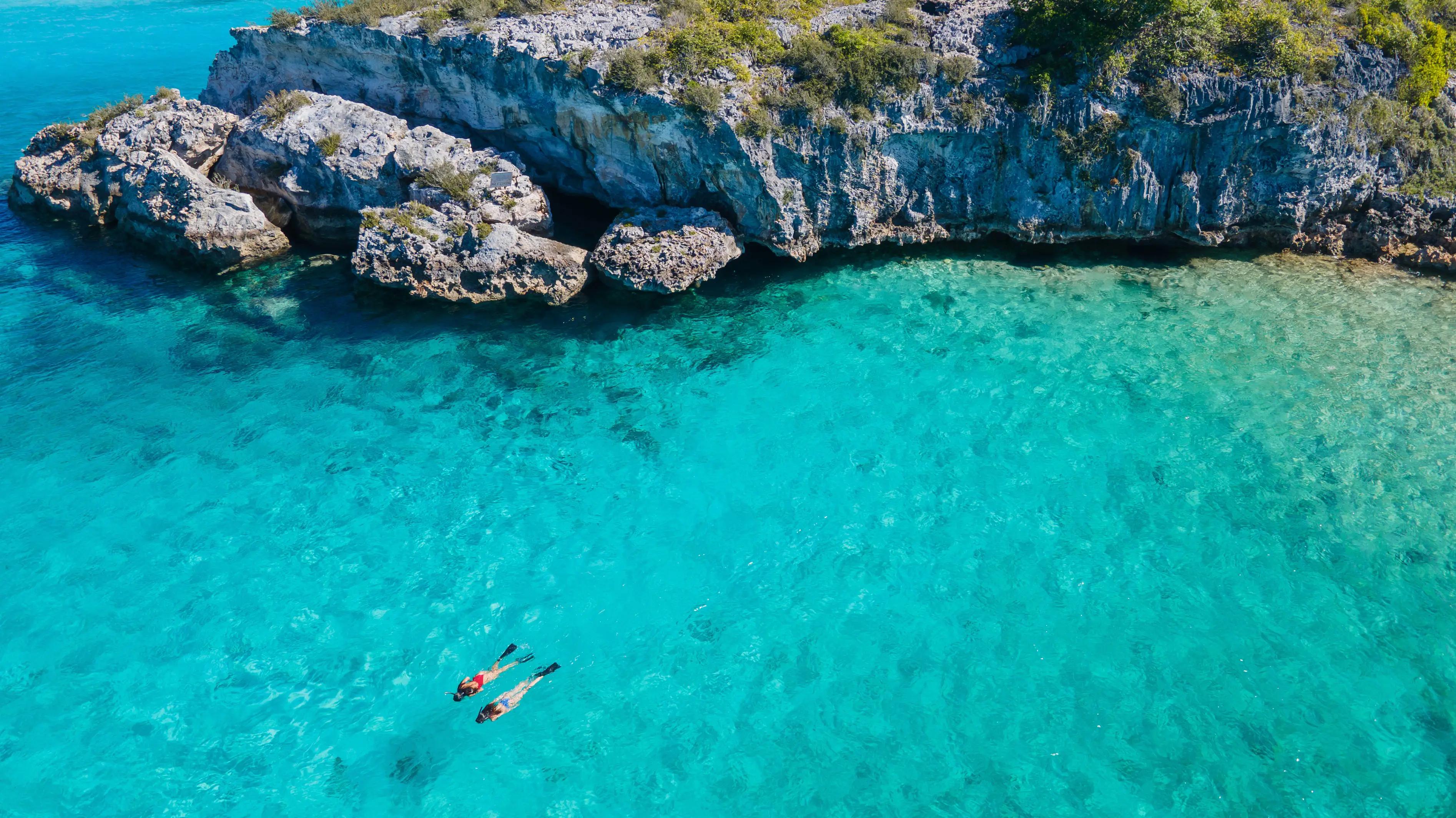 Exuma cove with two people snorkeling