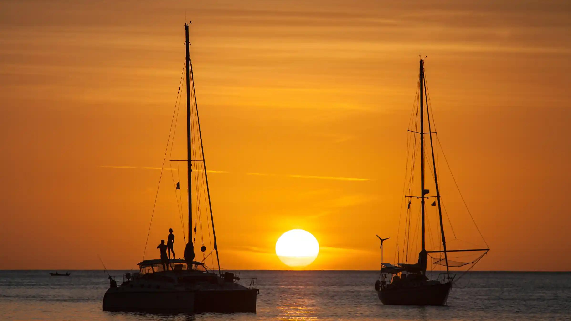 boats sailing at sunset