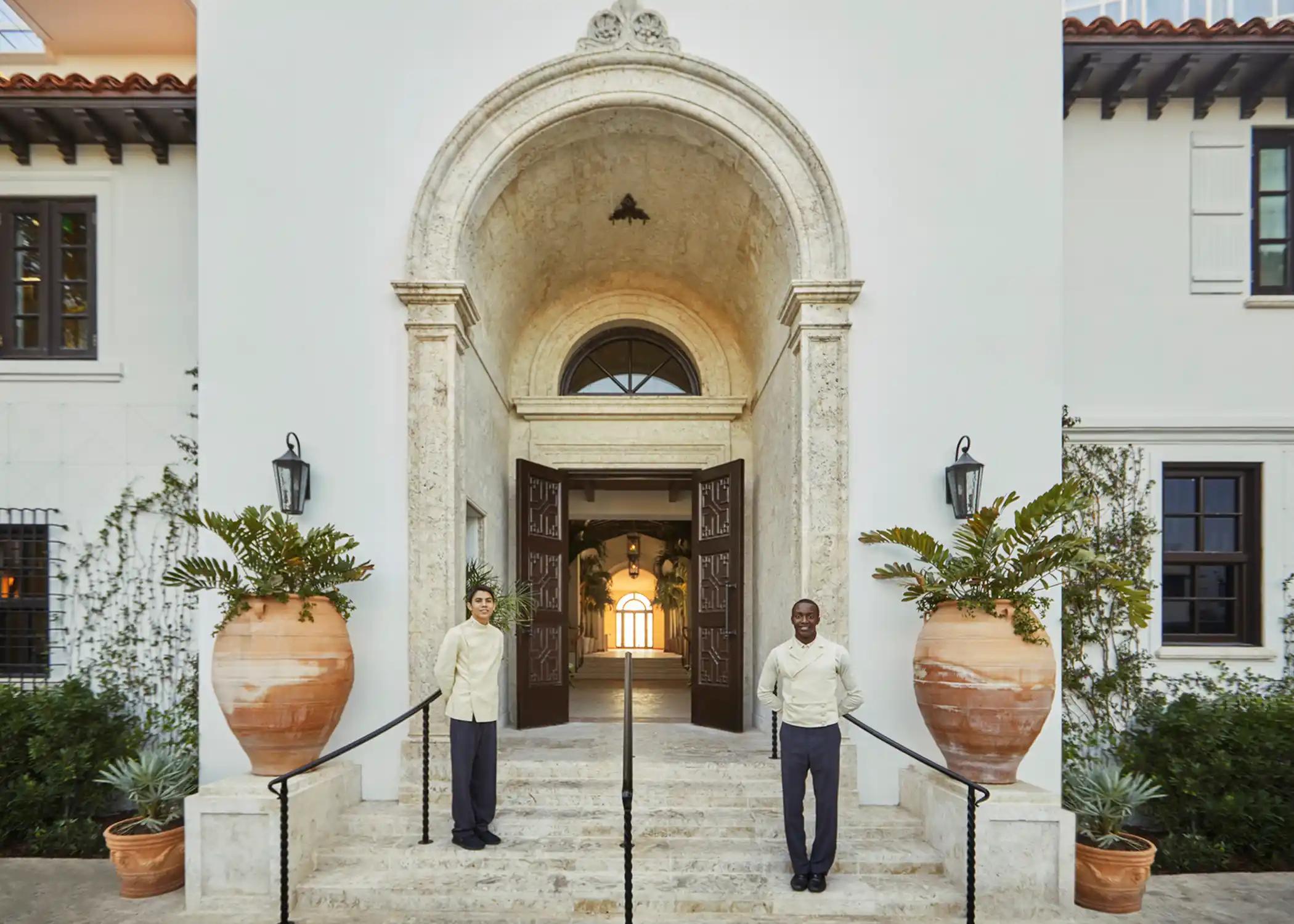 staff greeting guests at entrance to surf club.